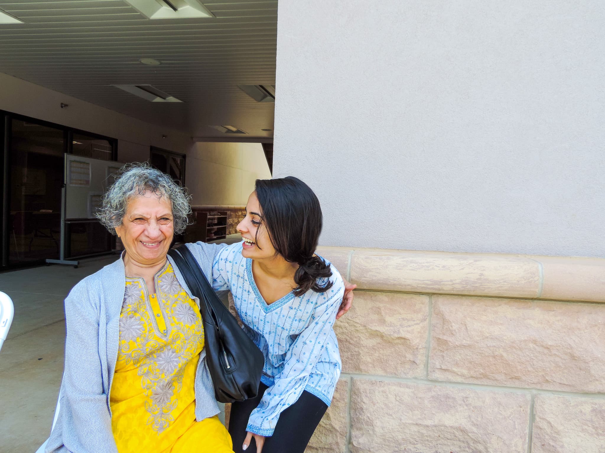 A senior and a companion sharing a laugh