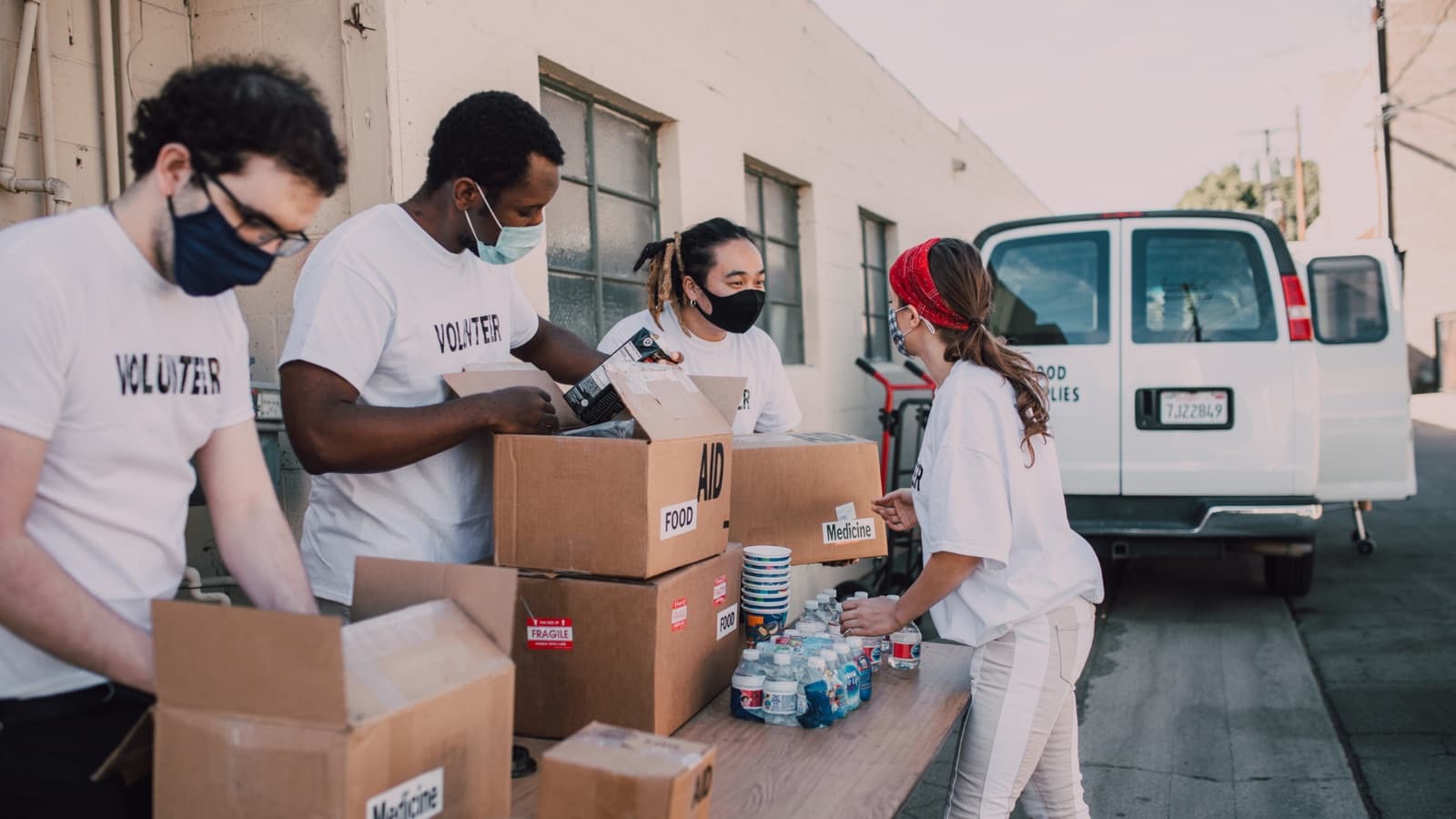 Volunteers loading food aid boxes for delivery