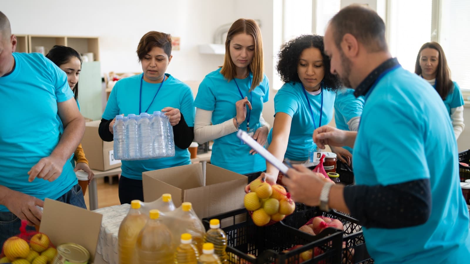 Volunteers packing grocery boxes for seniors
